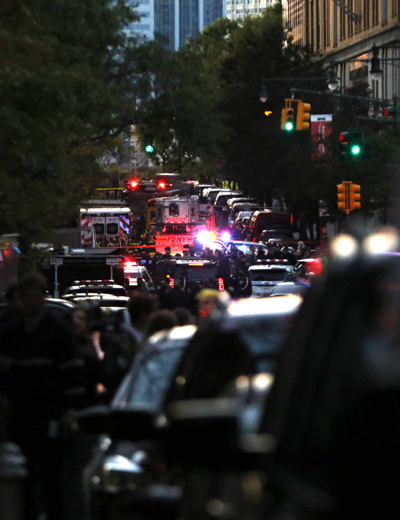 The New York Police and Fire Department assemble on Chambers Street in lower Manhattan after a man in a rented pickup truck mowed down pedestrians and cyclists along a busy bike path near the Worl ...