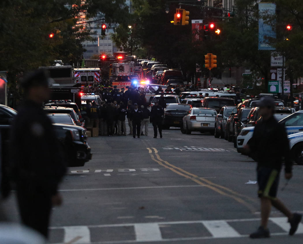 The New York Police and Fire Department assemble on Chambers Street in lower Manhattan after a man in a rented pickup truck mowed down pedestrians and cyclists along a busy bike path near the Worl ...