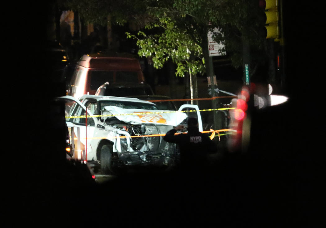 Authorities investigate near a rented Home Depot truck used to mow down pedestrians and cyclists along a busy bike path near the World Trade Center memorial on Tuesday, Oct. 31, 2017, killing at l ...