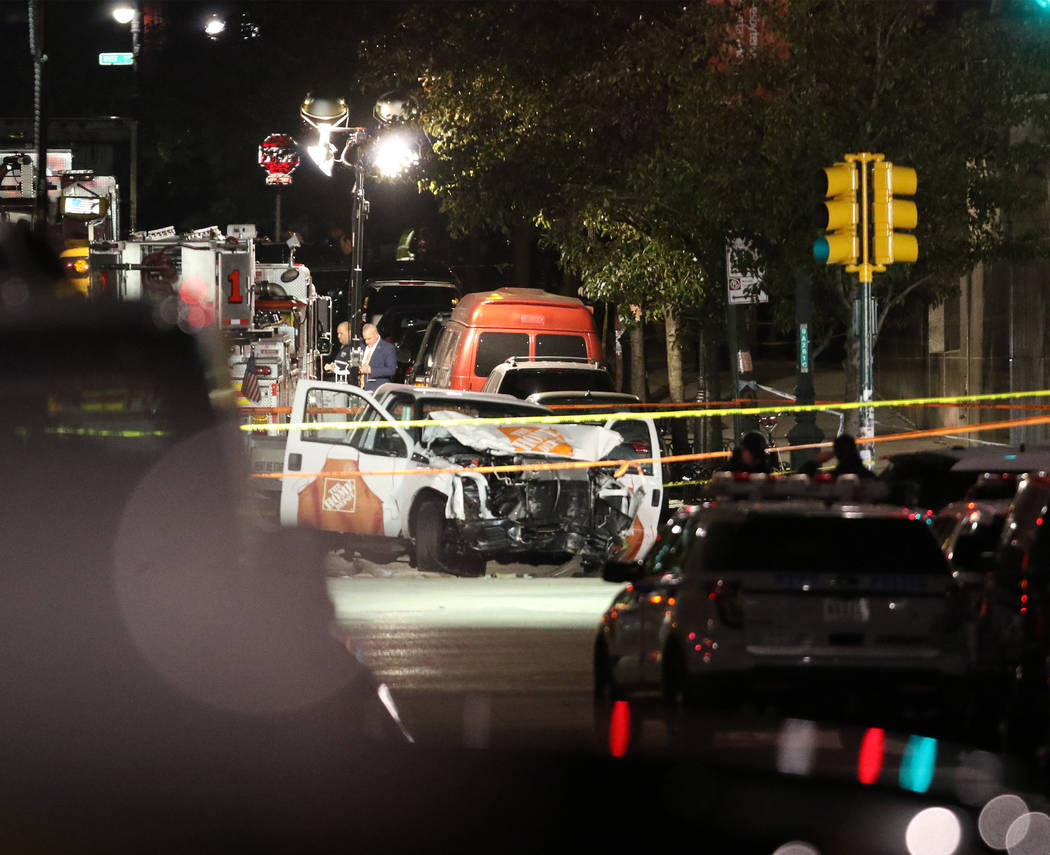 Authorities investigate near a rented Home Depot truck used to mow down pedestrians and cyclists along a busy bike path near the World Trade Center memorial on Tuesday, Oct. 31, 2017, killing at l ...