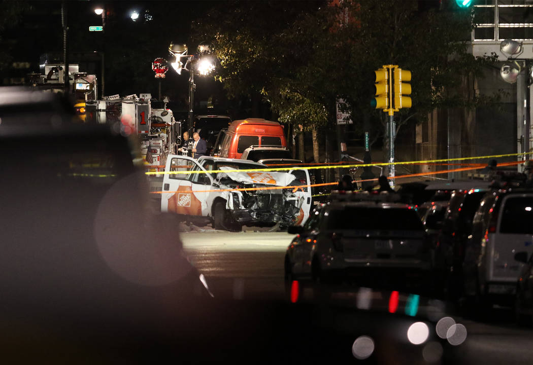 Authorities investigate near a rented Home Depot truck used to mow down pedestrians and cyclists along a busy bike path near the World Trade Center memorial on Tuesday, Oct. 31, 2017, killing at l ...