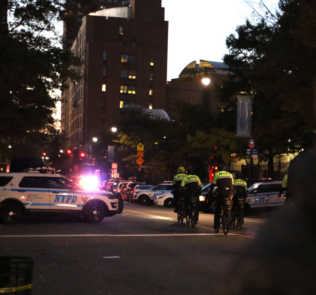New York police on bicycles patrol Chambers Street in lower Manhattan after a man in a rented pickup truck mowed down pedestrians and cyclists along a busy bike path near the World Trade Center me ...