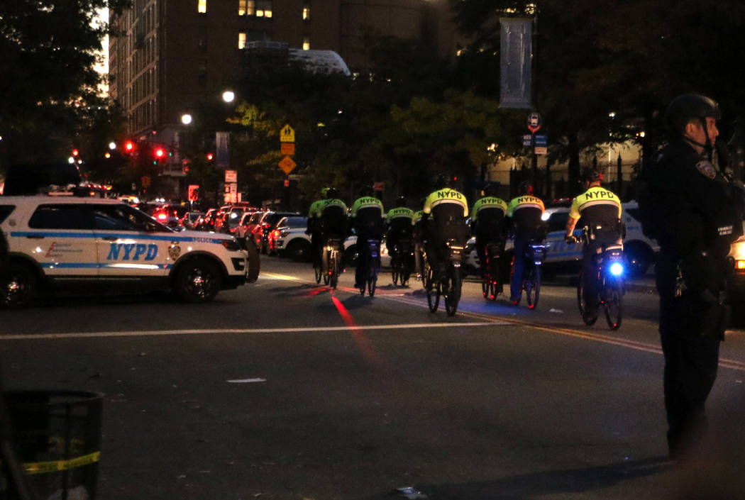 New York police on bicycles patrol Chambers Street in lower Manhattan after a man in a rented pickup truck mowed down pedestrians and cyclists along a busy bike path near the World Trade Center me ...