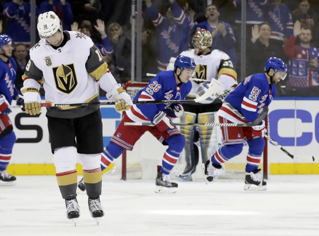 Vegas Golden Knights left wing James Neal, left, and goalie Maxime Lagace, react as New York Rangers center David Desharnais (51) and Jimmy Vesey (26) skate past him after Vesey scored a goal duri ...