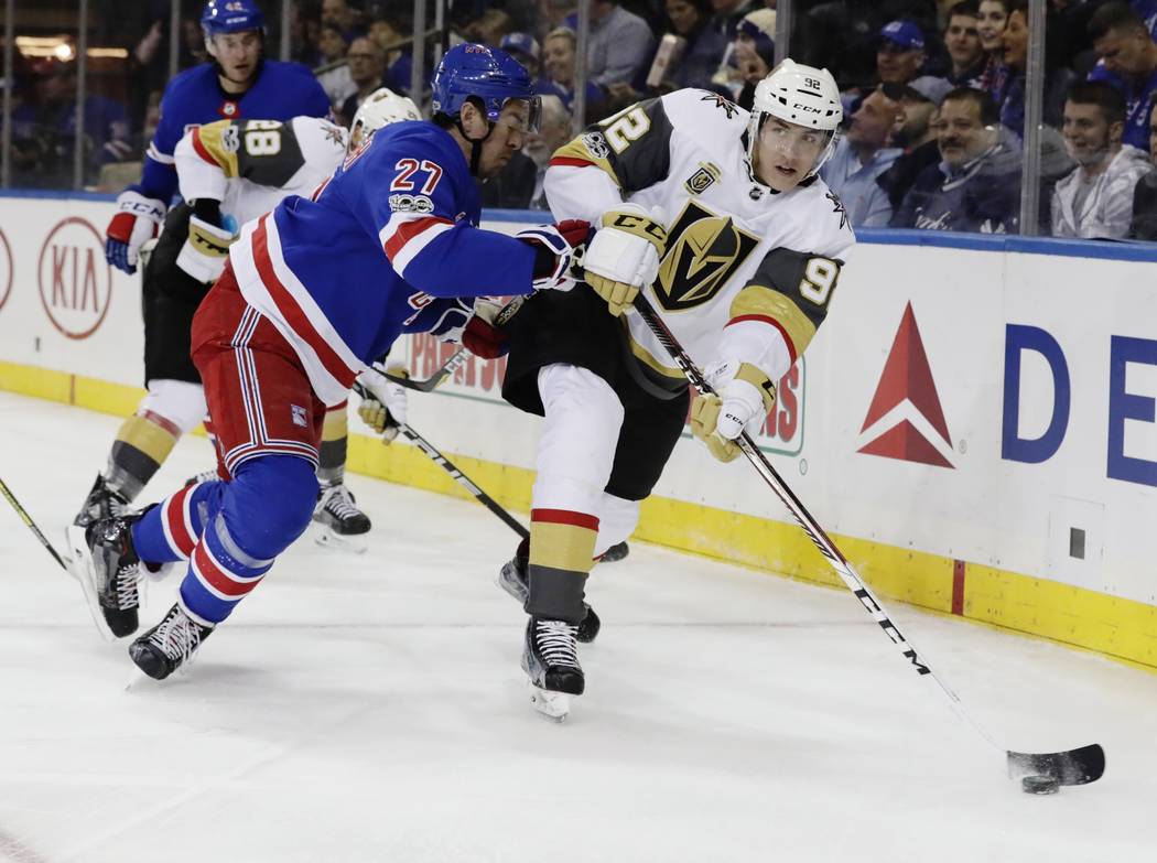 Vegas Golden Knights' Tomas Nosek (92) passes the puck away from New York Rangers' Ryan McDonagh (27) during the first period of an NHL hockey game Tuesday, Oct. 31, 2017, in New York. (AP Photo/F ...