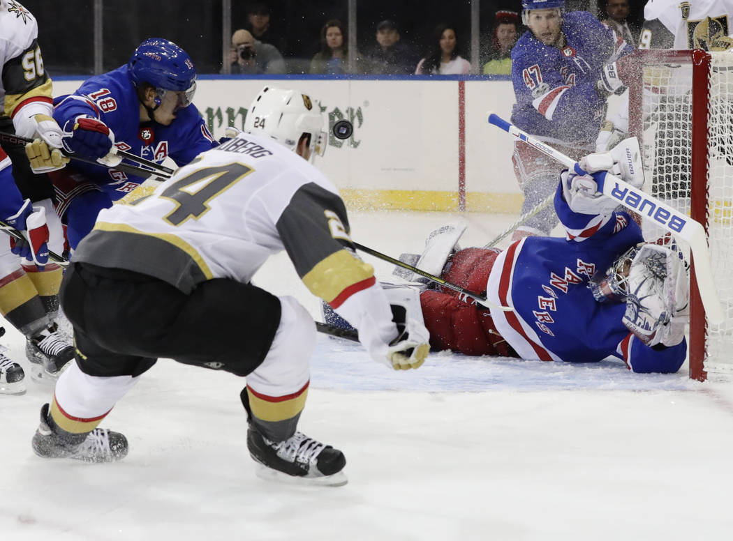 Vegas Golden Knights' Oscar Lindberg (24) shoots the puck past New York Rangers goalie Henrik Lundqvist (30) for a goal during the first period of an NHL hockey game Tuesday, Oct. 31, 2017, in New ...
