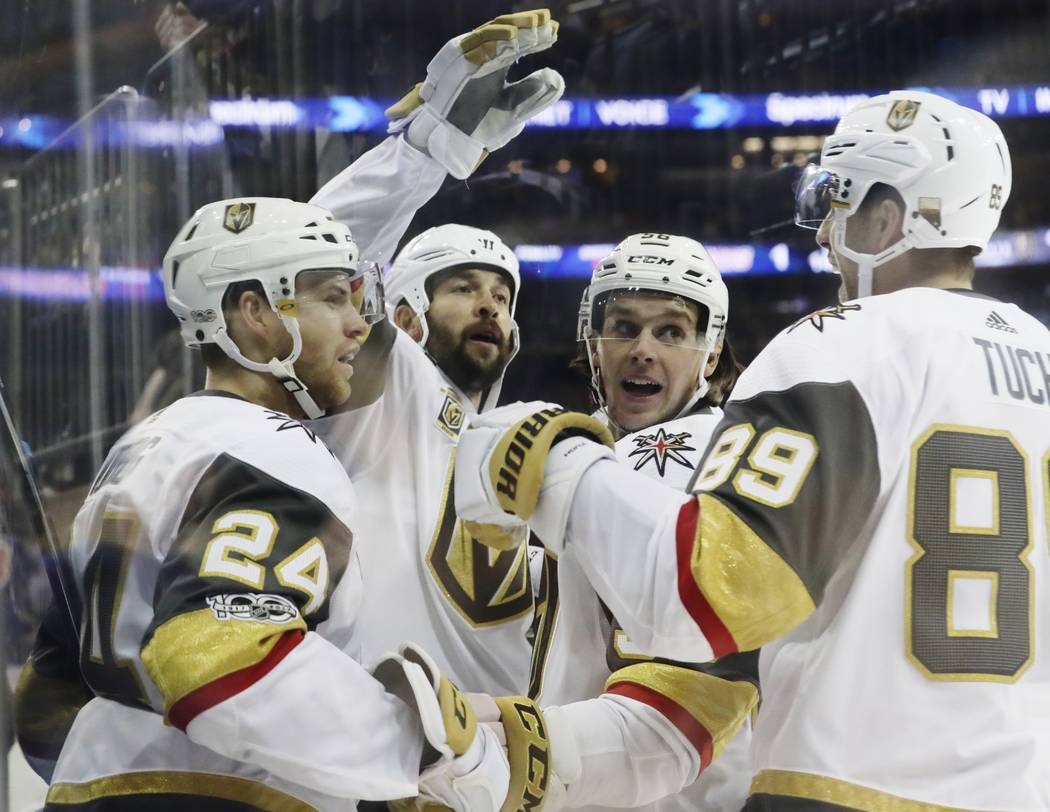 Vegas Golden Knights' Oscar Lindberg (24) celebrates his goal with teammates Alex Tuch (89) and Erik Haula (56) after scoring during the first period of an NHL hockey game against the New York Ran ...