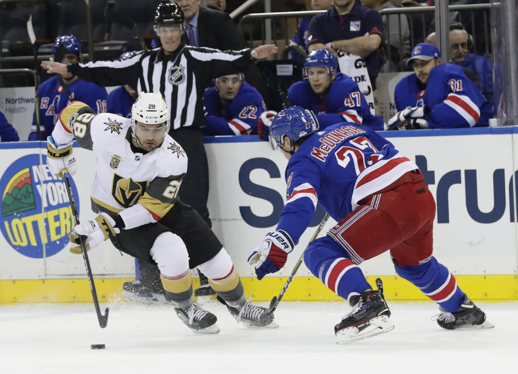 Vegas Golden Knights' William Carrier (28) and New York Rangers' Ryan McDonagh (27) fights for control of the puck during the first period of an NHL hockey game Tuesday, Oct. 31, 2017, in New York ...