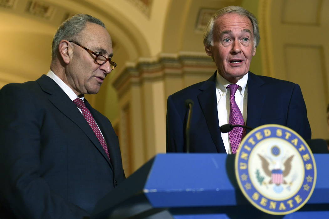 Senate Minority Leader Sen. Chuck Schumer of N.Y., left, and Sen. Edward Markey, D-Mass., right, speak to reporters following the weekly Democratic policy luncheon on Capitol Hill in Washington, T ...