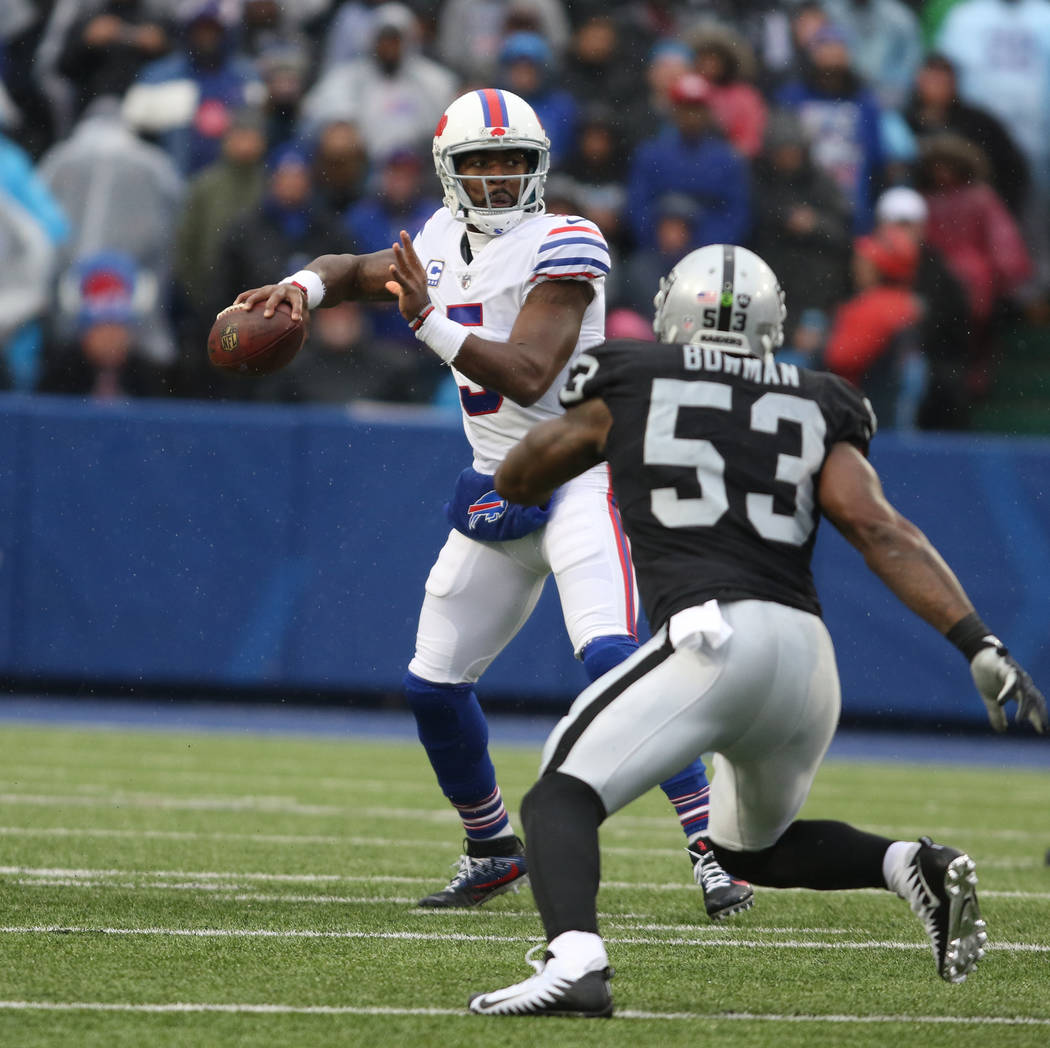 Buffalo Bills quarterback Tyrod Taylor (5) prepares to throw the football as Oakland Raiders middle linebacker NaVorro Bowman (53) pressures him during the first half of the NFL game in Orchard Pa ...