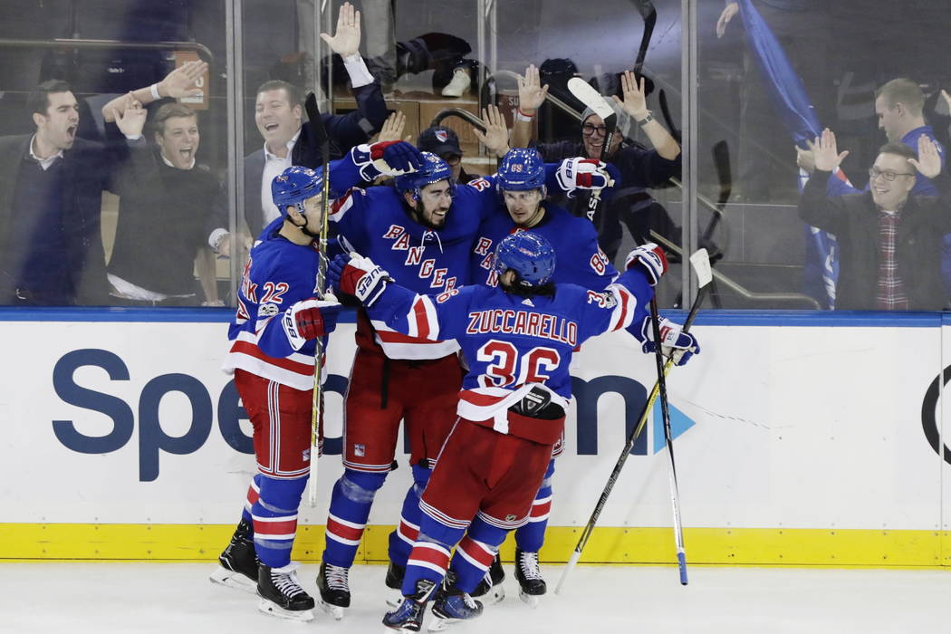 Mika Zibanejad, center, celebrates with teammates Mats Zuccarello (36), Kevin Shattenkirk (22) and Pavel Buchnevich (89) after scoring a goal during the third period of an NHL hockey game against  ...