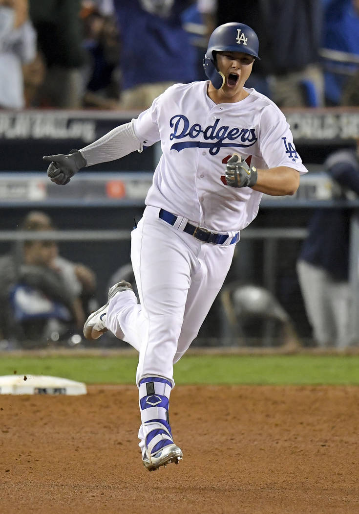 Los Angeles Dodgers' Joc Pederson celebrates his home run against the Houston Astros during the seventh inning of Game 6 of baseball's World Series Tuesday, Oct. 31, 2017, in Los Angeles. (AP Phot ...