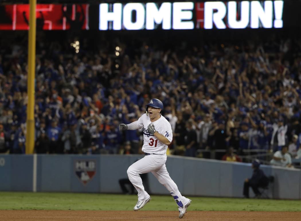 Los Angeles Dodgers' Joc Pederson celebrates after hitting a home run during the seventh inning of Game 6 of baseball's World Series against the Houston Astros Tuesday, Oct. 31, 2017, in Los Angel ...