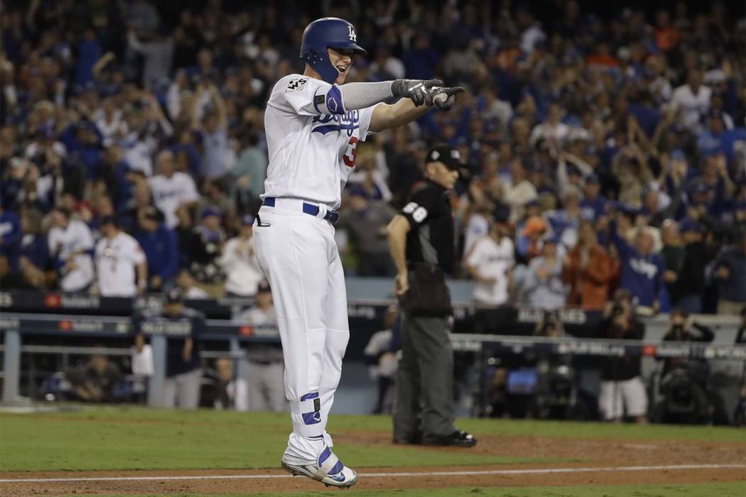 Los Angeles Dodgers' Joc Pederson celebrates after hitting a home run during the seventh inning of Game 6 of baseball's World Series against the Houston Astros Tuesday, Oct. 31, 2017, in Los Angel ...