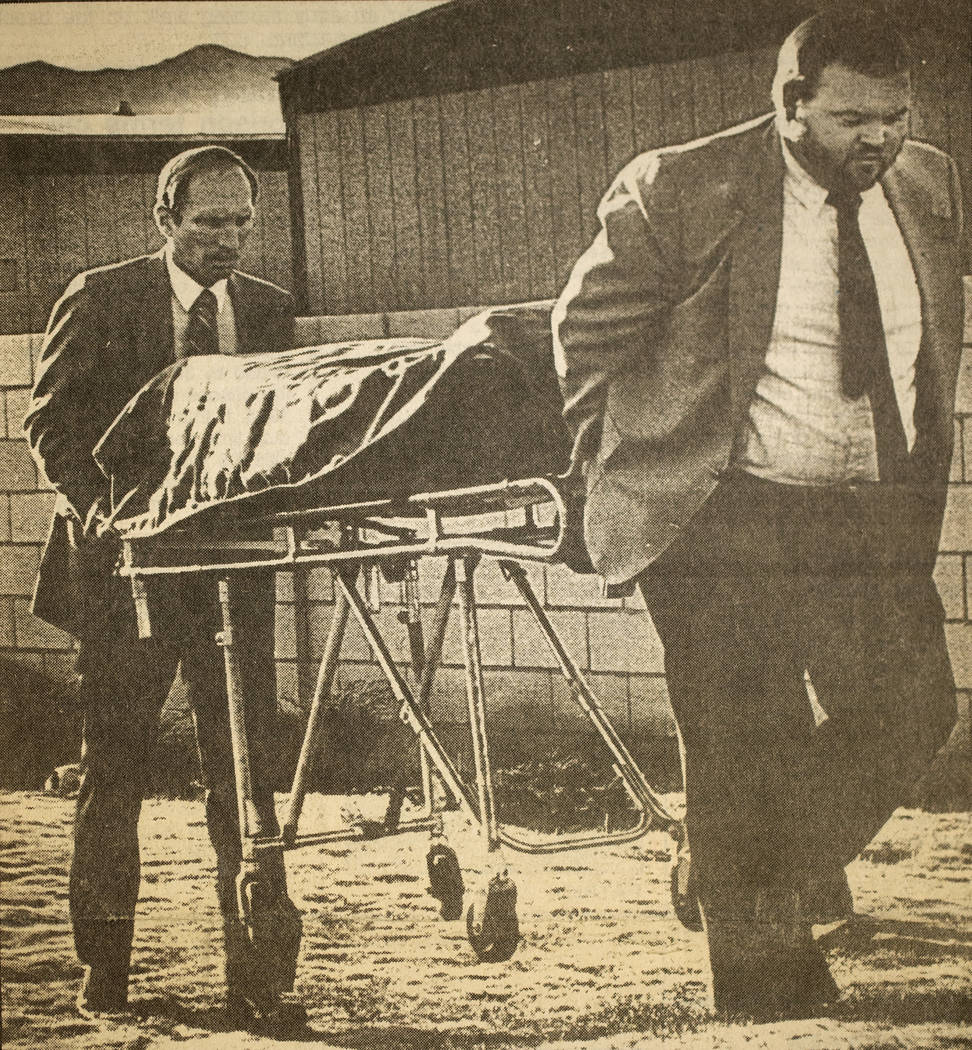 Workers from Palm Mortuary remove the body of Alexander Harris after it was found beneath a mobile home at Whiskey Pete's Casino in Stateline, now known as Primm, on Dec. 30, 1987. The 7-year-old  ...