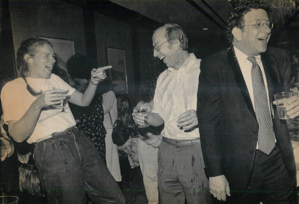 Howard Lee Haupt, center, is drenched with Champagne at a party marking his acquittal on Feb. 15, 1989, in the death of Alexander Harris. Haupt's fiancee, Tina Van Den Hazel, left, and defense att ...