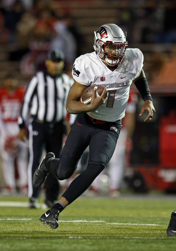 UNLV quarterback Armani Rogers runs for yardage during the second half of an NCAA college football game against New Mexico in Albuquerque, N.M., Friday, Nov. 17, 2017. (AP Photo/Andres Leighton)