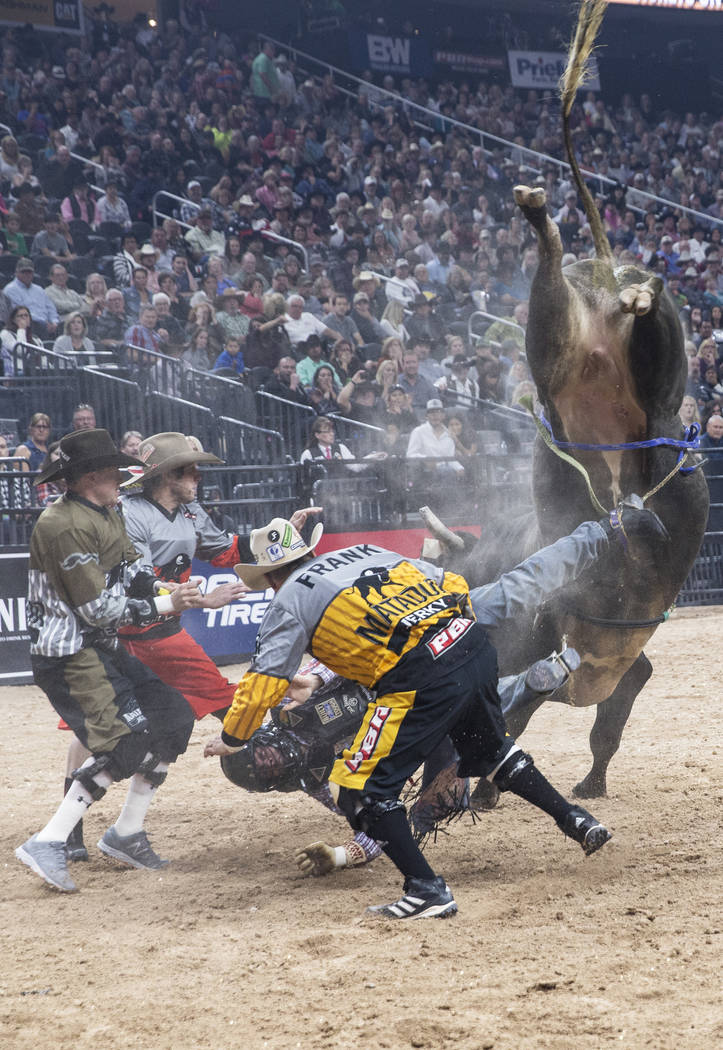 Bullfighters try to help Lachlan Richardson get unhooked from Freak of Nature during the Professional Bull Riders World Finals on Sunday, Nov. 5, 2017, at T-Mobile Arena, in Las Vegas. Benjamin Ha ...