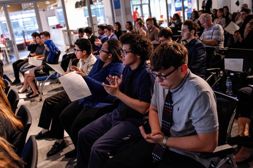 Basic High School students Filipe Deandrade, 18, second from right, and Joshua Gutierrez, 16, right, applaud during the CTA Future Innovators Business Pitch Competition at the RedFlint Experience ...