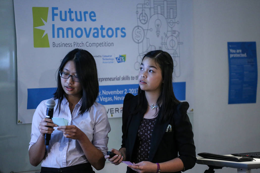 Southwest Career and Technical Academy students Fiorina Chau, 15, left, and Amber To, 15, right, present during the CTA Future Innovators Business Pitch Competition at the RedFlint Experience Cent ...