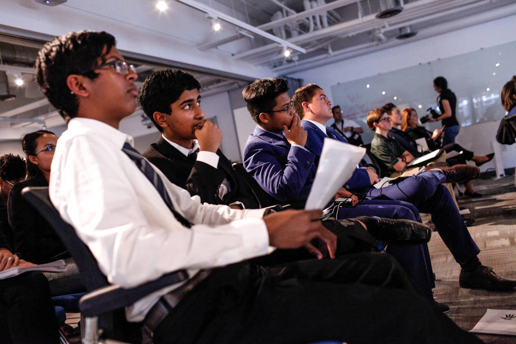 Southwest Career and Technical Academy students Ishaan Raja, 15, left, and Anish Ghejerla, 15, second from left, listen to presentations during the CTA Future Innovators Business Pitch Competition ...