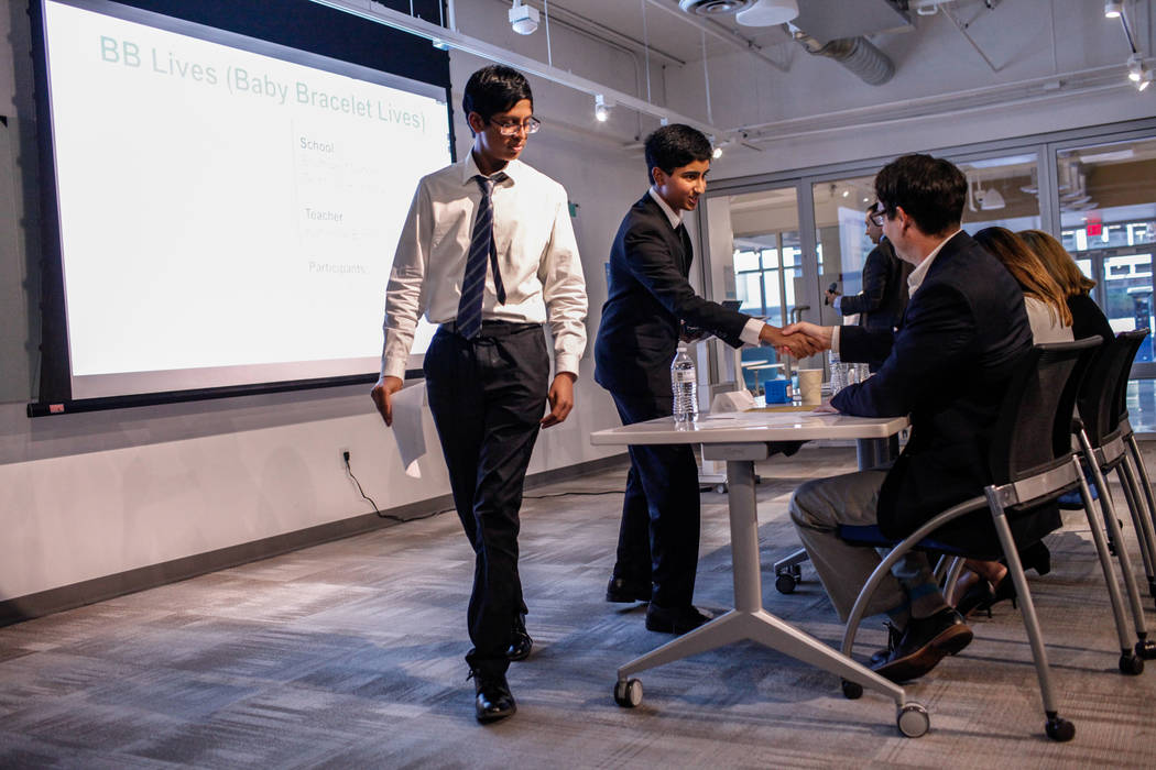 Southwest Career and Technical Academy students Ishaan Raja, 15, left, and Anish Ghejerla, 15, right, shake hands with judges after presenting during the CTA Future Innovators Business Pitch Compe ...