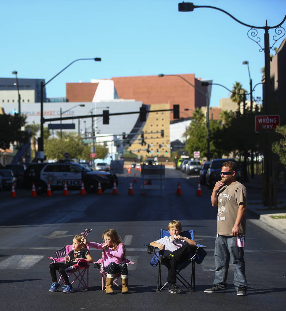 Chris Callahan, right, and his family watch parade participants pass by during the Veterans Day Parade in downtown Las Vegas on Saturday, Nov. 11, 2017. Chase Stevens Las Vegas Review-Journal @css ...