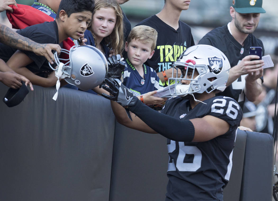 Oakland Raiders safety Shalom Luani (26) signs autographs prior to a preseason game against the Seattle Seahawks in Oakland, Calif., Thursday, Aug. 31, 2017. Heidi Fang Las Vegas Review-Journal @H ...
