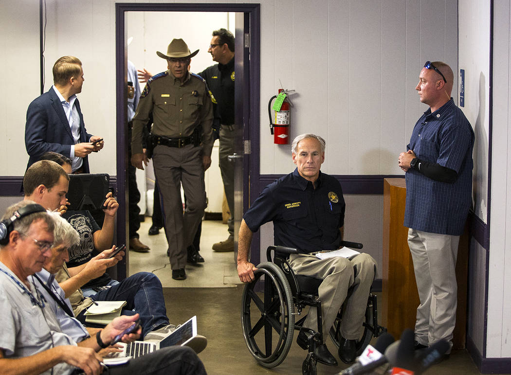 Texas Gov. Greg Abbott arrives to the Stockdale Community Center to address members of the media about a deadly shooting at the First Baptist Church in Sutherland Springs, during a press conferenc ...