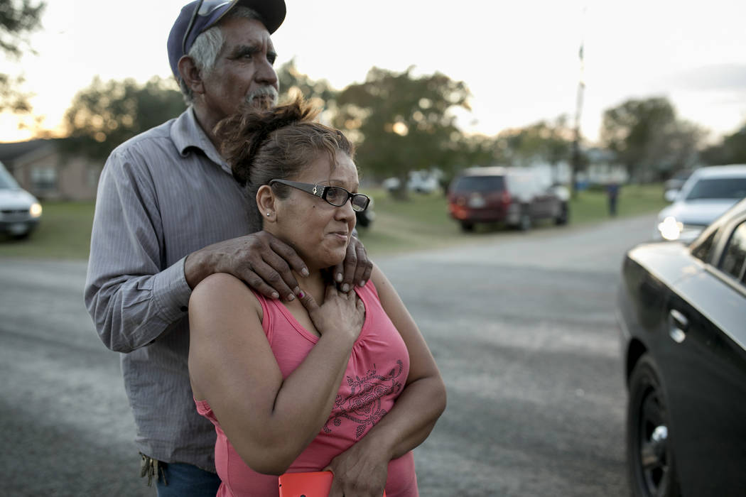 Enrique and Gabby Garcia watch investigators at the scene of a mass shooting at the First Baptist Church in Sutherland Springs, Texas, on Sunday Nov. 5, 2017. A man opened fire inside of the churc ...