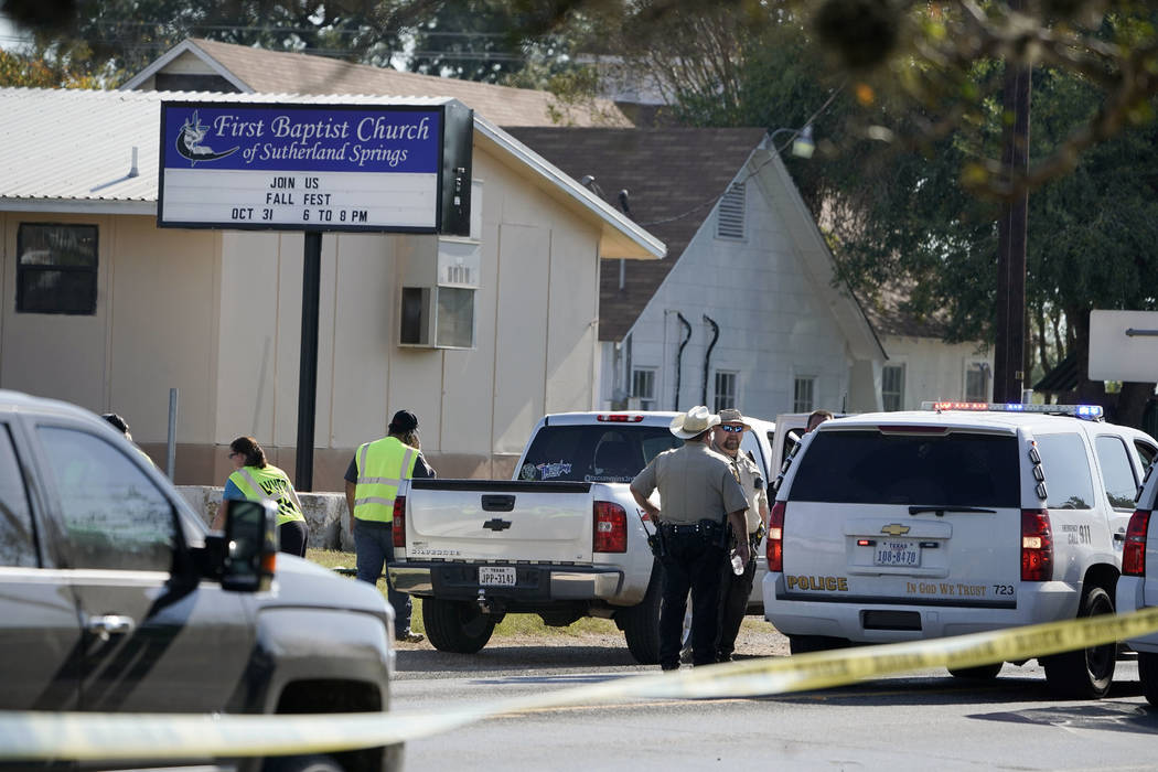 Law enforcement officers gather in front of the First Baptist Church of Sutherland Springs after a fatal shooting, Sunday, Nov. 5, 2017, in Sutherland Springs, Texas. (AP Photo/Darren Abate)