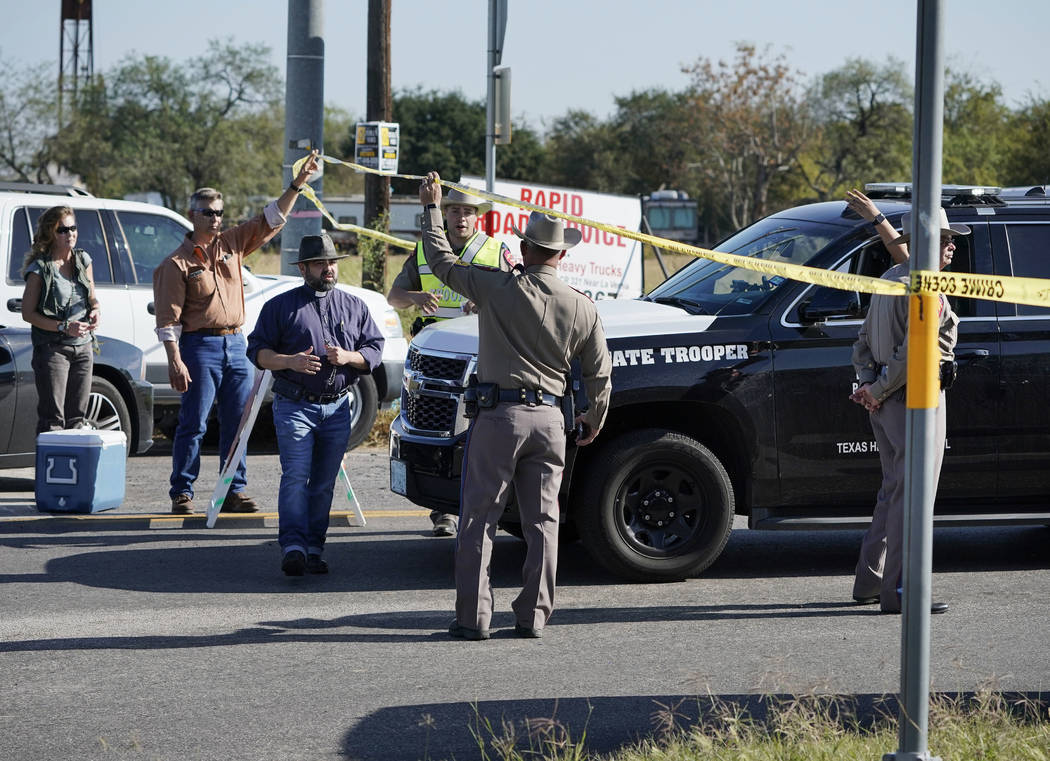 Law enforcement officers man a barricade near the First Baptist Church of Sutherland Springs after a fatal shooting, Sunday, Nov. 5, 2017, in Sutherland Springs, Texas. (AP Photo/Darren Abate)