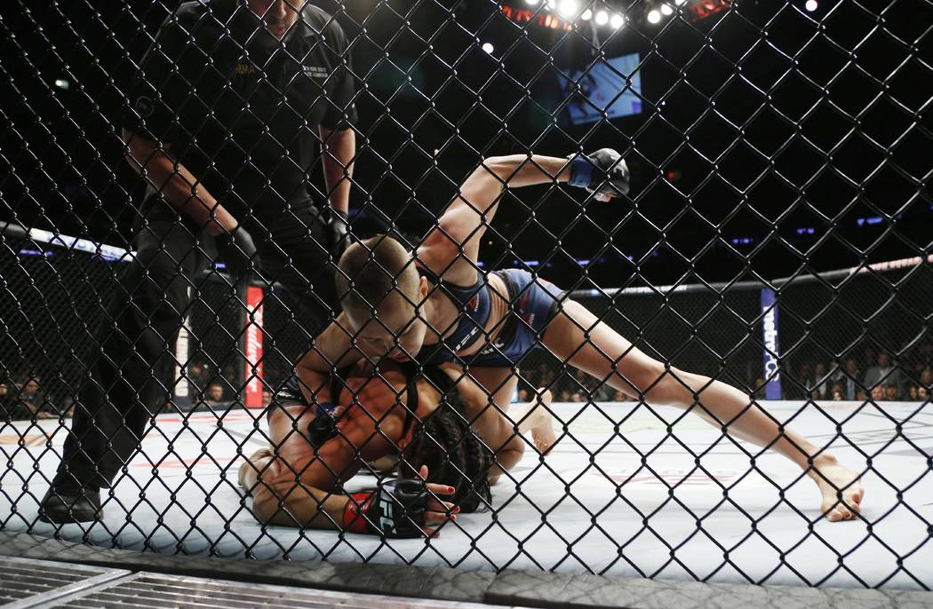 Nov 4, 2017; New York, NY, USA;  Rose Namajunas (blue gloves) fights Joanna Jedrzejczyk (red gloves) during UFC 217 at Madison Square Garden. (Noah K. Murray-USA TODAY Sports)