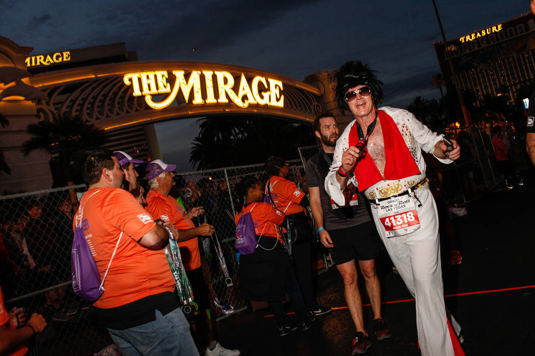 Mike Christie of Nepean crosses the finish line at the 10K run of the Rock 'n' Roll Las Vegas Marathon along the Strip near The Mirage in Las Vegas, Sunday, Nov. 12, 2017. Joel Angel Juarez Las Ve ...