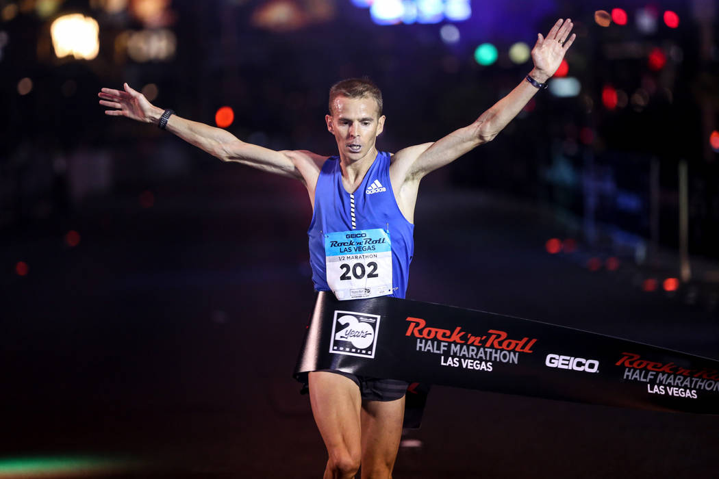Jeffrey Eggleston of Boulder crosses the finish line for first place of the men's half marathon run of the Rock 'n' Roll Las Vegas Marathon along the Strip near The Mirage in Las Vegas, Sunday, No ...