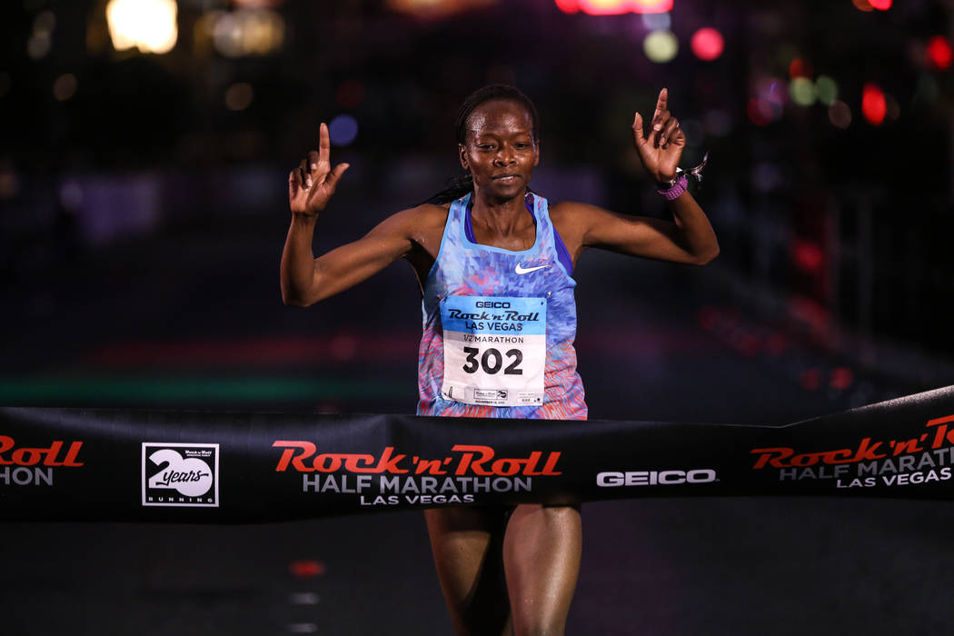 Janet Bawcom of Flagstaff crosses the finish line for first place at the women's half marathon run of the Rock 'n' Roll Las Vegas Marathon along the Strip near The Mirage in Las Vegas, Sunday, Nov ...