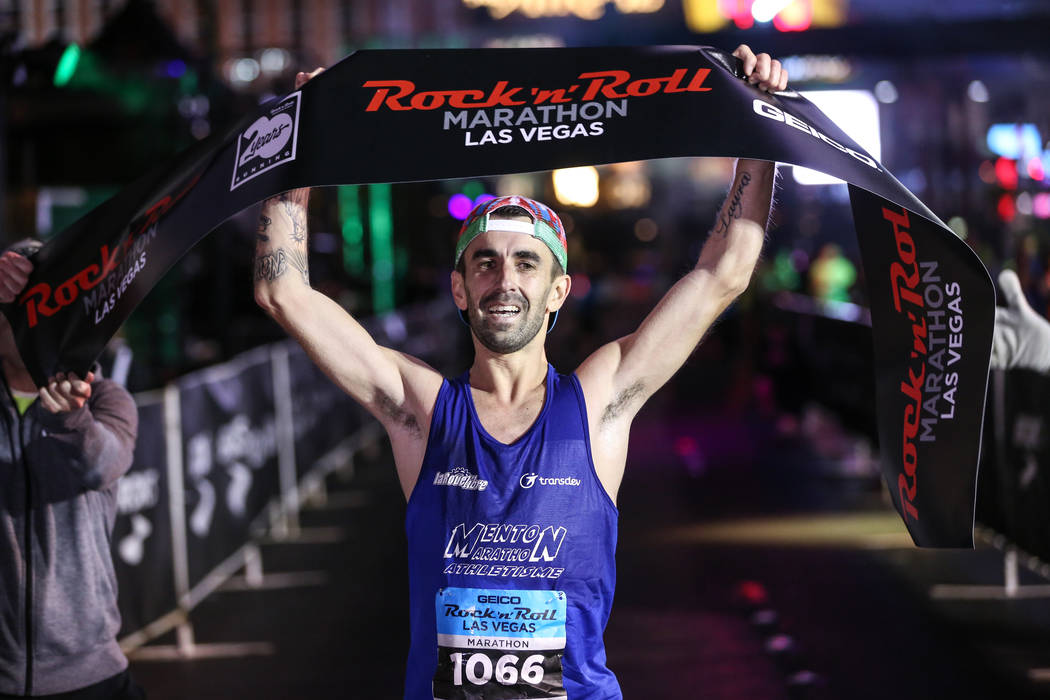 Gilles Rubio of Roquebrune Cap Martin, France, crosses the finish line winning first place at the men's marathon run of the Rock 'n' Roll Las Vegas Marathon along the Strip near The Mirage in Las ...