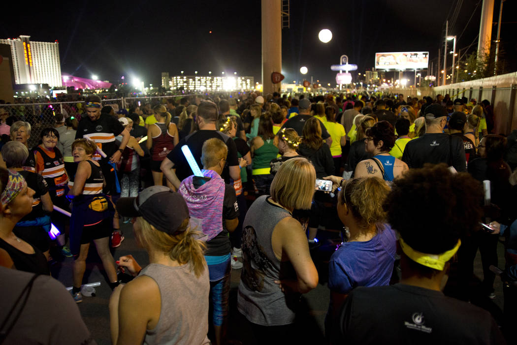 Runners wait for their corral number to be called to the start line during the 5K portion of the Rock ԮՠRoll Las Vegas Marathon at the Las Vegas Festival Grounds on The Strip on Saturd ...