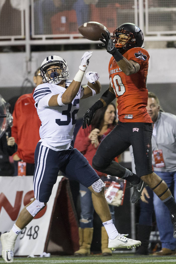 UNLV Rebels wide receiver Brandon Presley (80) makes a catch against Brigham Young Cougars defensive back Chris Wilcox (32) in the football game at Sam Boyd Stadium in Las Vegas, Friday, Nov. 10, ...