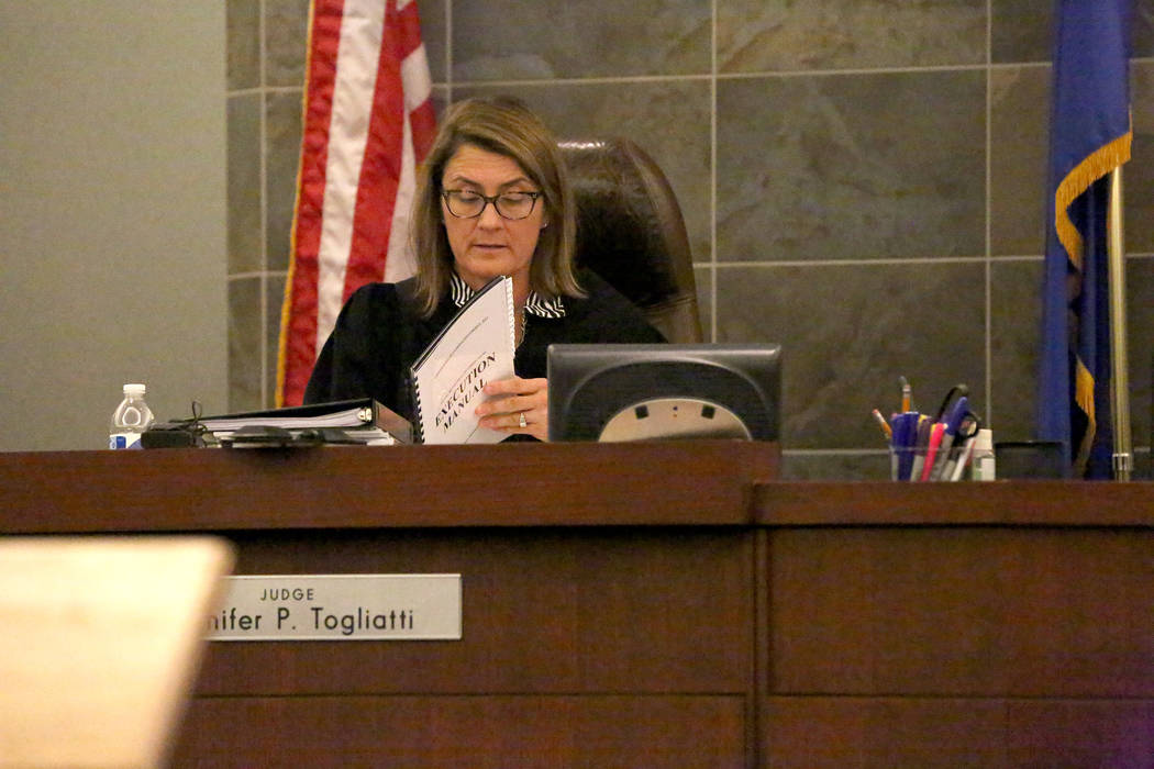 District Judge Jennifer Togliatti reviews protocols in the execution manual during a hearing for Scott Dozier on Wednesday, Nov. 8, 2017, at the Regional Justice Center in Las Vegas. Michael Quine ...