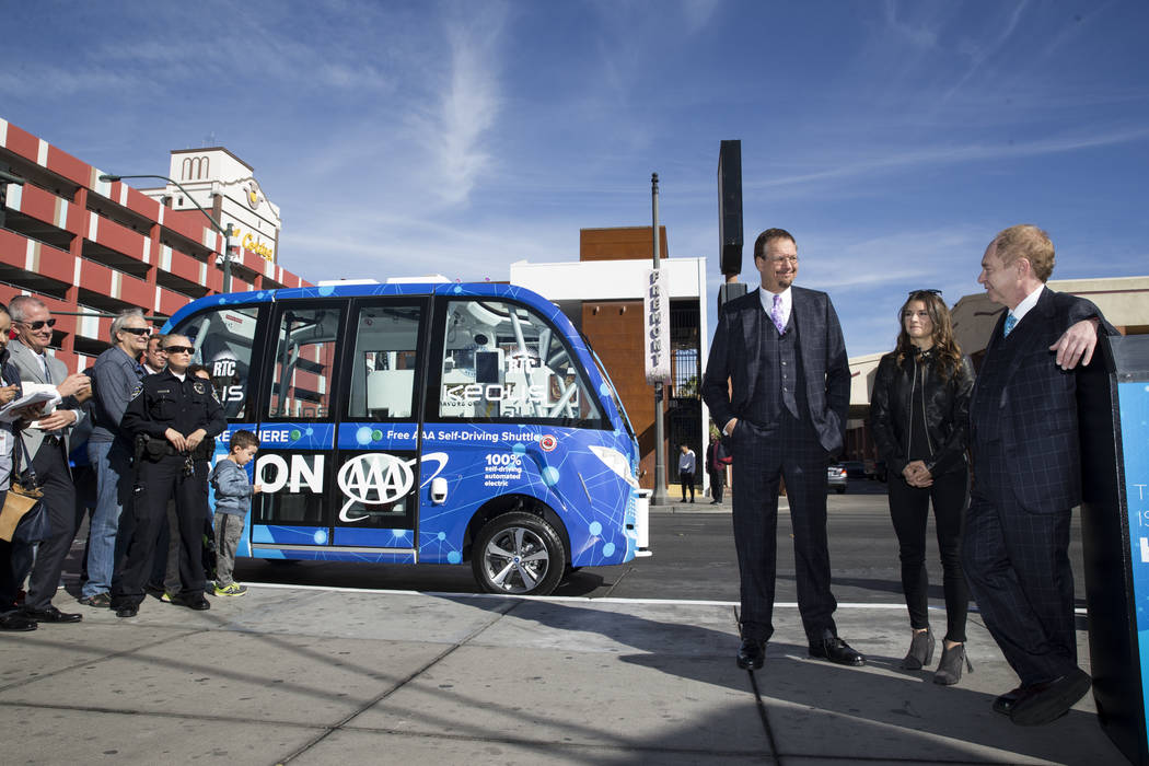 NASCAR driver Danica Patrick, center, with magicians Penn Jillette, left, and Raymond Teller of Penn and Teller, during the launch event of a driverless electric shuttle at the Container Park in L ...