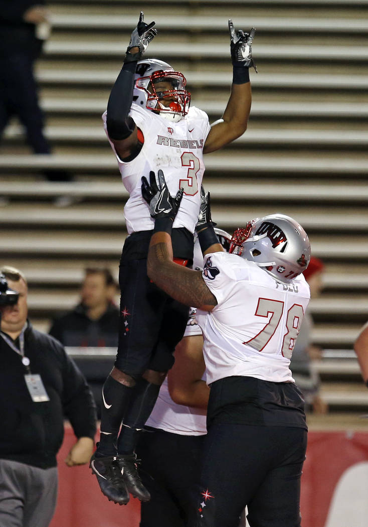 UNLV running back Lexington Thomas (3) celebrates with offensive lineman Justin Polu (78) after scoring a touchdown against New Mexico during the first half of an NCAA college football game in Alb ...