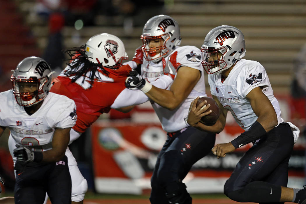 UNLV quarterback Armani Rogers, right, runs to the end zone for a touchdown during the first half of an NCAA college football game against New Mexico in Albuquerque, N.M., Friday, Nov. 17, 2017. ( ...