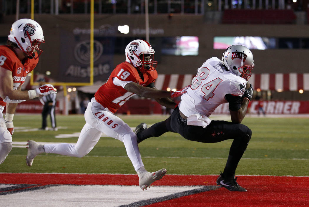 UNLV wide receiver Kendal Keys (84) catches a pass in the end zone to score the go-ahead touchdown as New Mexico cornerback Elijah Lilly (19) defends during the second half of an NCAA college foot ...