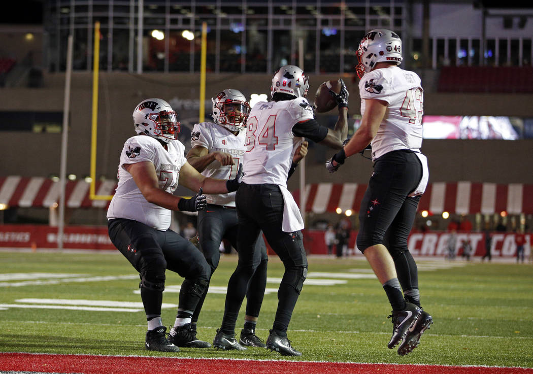 UNLV wide receiver Kendal Keys (84) celebrates with teammates after scoring the go-ahead touchdown against New Mexico during the second half of an NCAA college football game in Albuquerque, N.M.,  ...