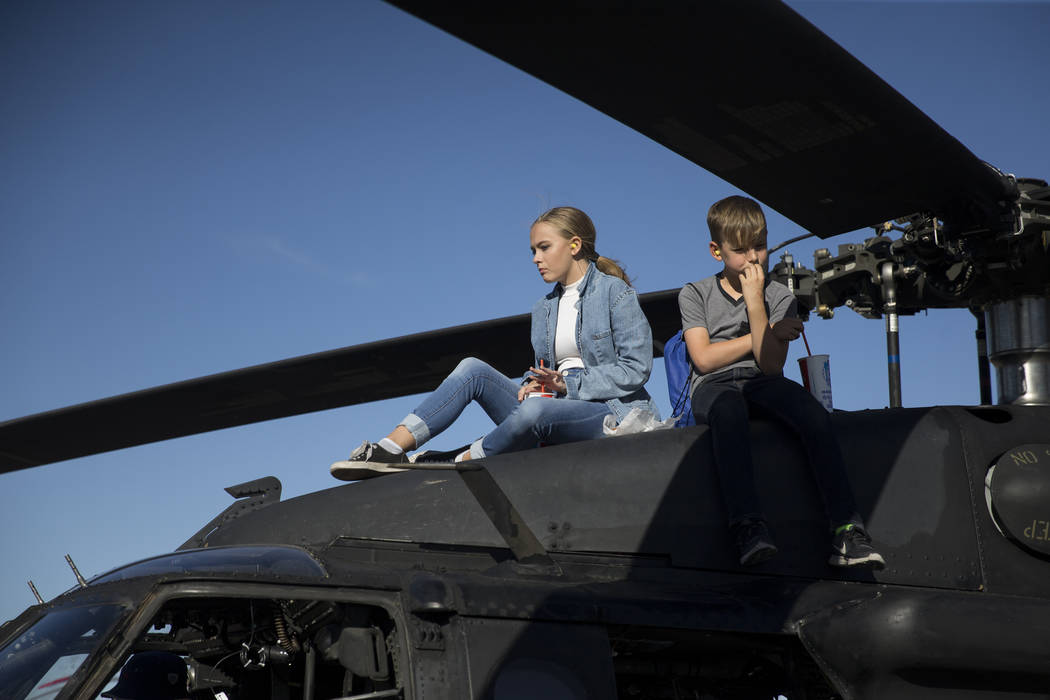 Shela Aldis, left, 15, and her friend Tyler Hollar, 11, sit on top of a MH-60M assault helicopter during Aviation Nation at Nellis Air Force Base in Las Vegas, Saturday, Nov. 11, 2017. Erik Verduz ...