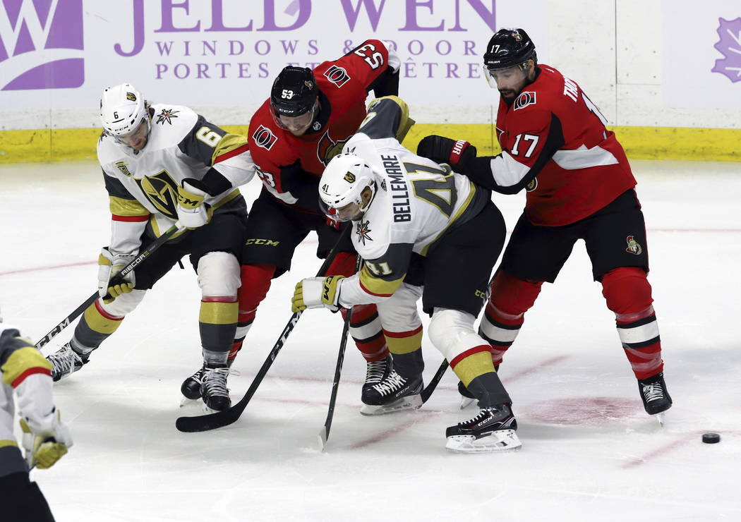Vegas Golden Knights defenseman Colin Miller (6) and left wing Pierre-Edouard Bellemare (41) along with Ottawa Senators right wing Jack Rodewald (53) and center Nate Thompson (17) look for a loose ...