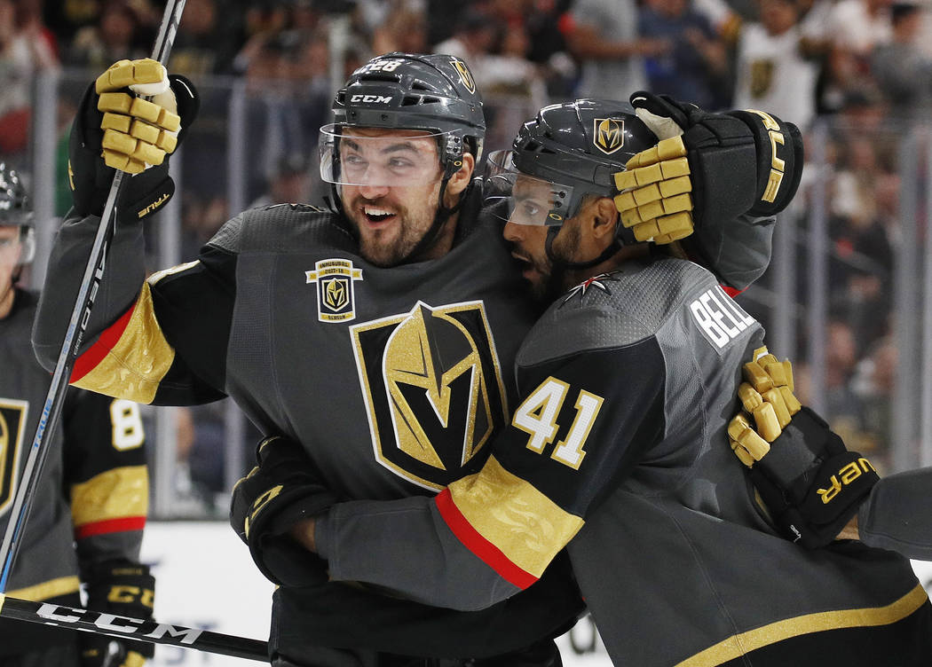 Vegas Golden Knights' William Carrier, left, and Pierre-Edouard Bellemare celebrate after Bellemare scored against the Chicago Blackhawks during the second period of an NHL hockey game Tuesday, Oc ...