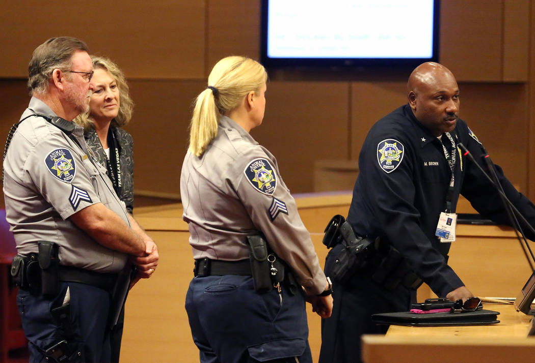 Las Vegas Department of Safety Deputy Chief, Michael Brown, right, speaks as Cynthia Leavitt, and Jim Rodger, left, both Animal Control supervisors, look on during the City Council meeting at Las  ...