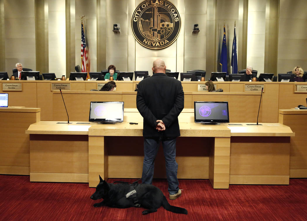 U.S. Army veteran Michael Neil, accompanied by his service dog Yamas, speaks during the City Council meeting at Las Vegas City Hall Wednesday, Nov. 15, 2017. Neil supports the repeal of a ban that ...